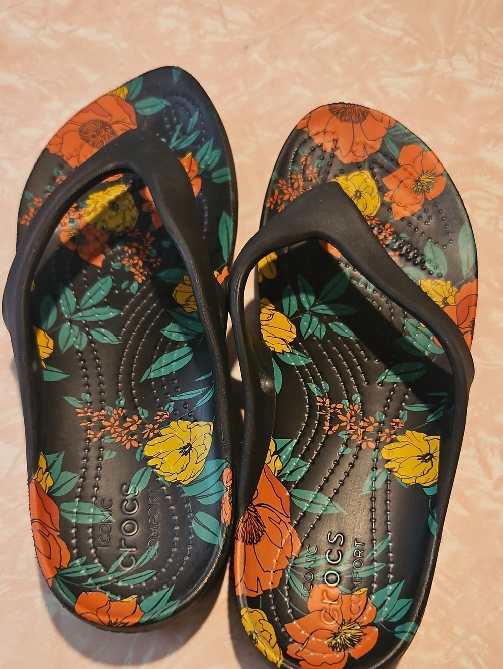 CROCS Black Flip Flop Sandals with Orange & Yellow Floral Print